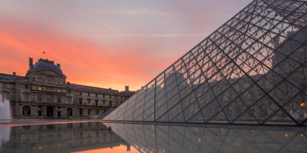 PARIS, FRANCE - DECEMBER 9, 2016- View of famous Louvre Museum with Louvre Pyramid at evening. Louvre Museum is one of the largest and most visited museums worldwide