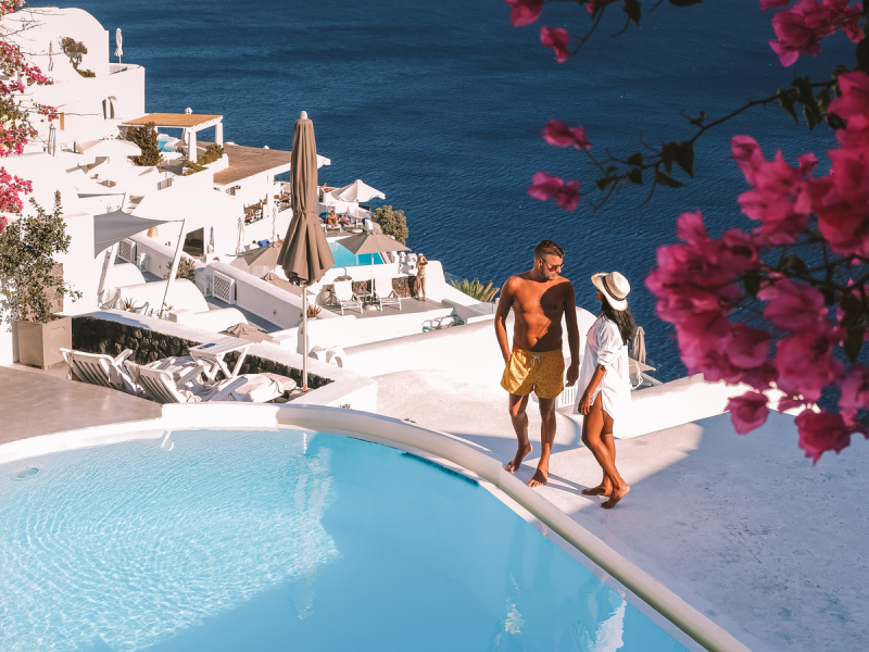 Santorini Island Greece, couple men and woman on vacation at the Greek Island of Santorini visit the white village of Oia Santorini. Greece